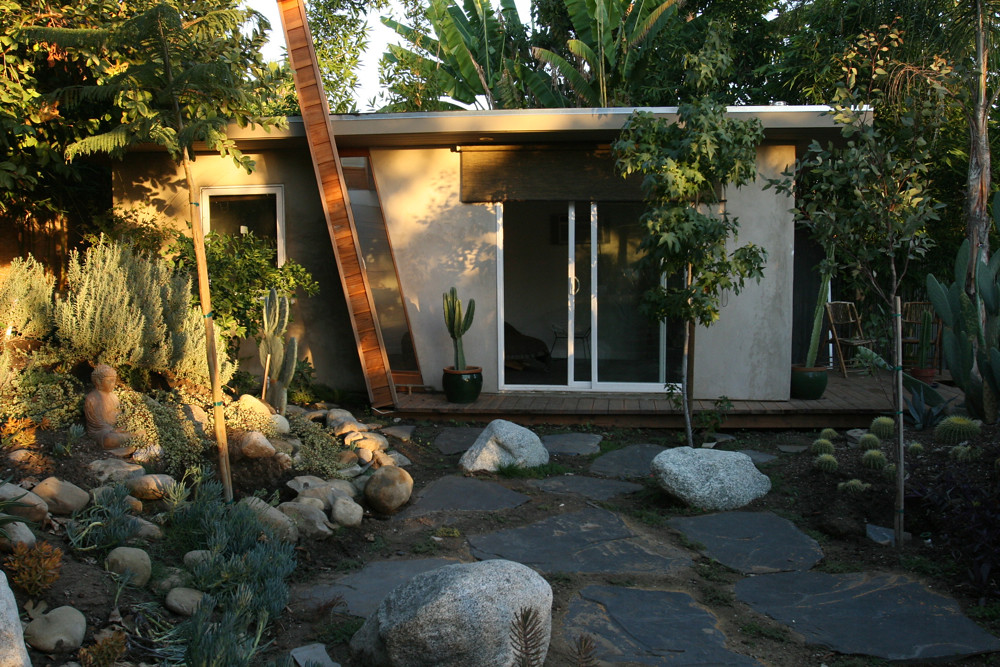 A landscaped courtyard with stone paving, boulders and drought-tolerant planting